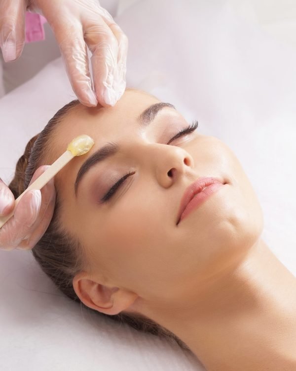 Beautician,Is,Removing,Hair,From,Beautiful,Female,Face,With,Hot